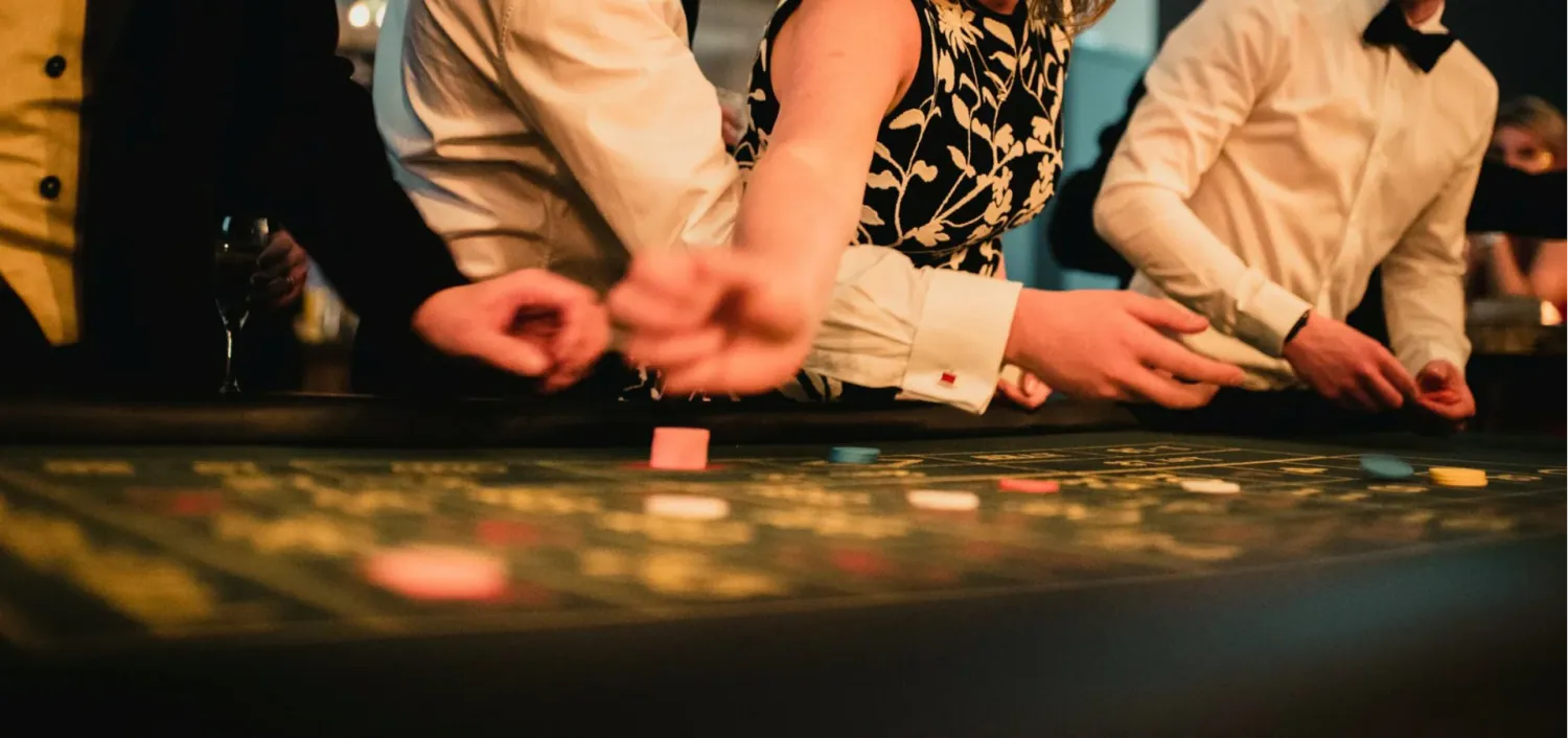 Guests playing at a casino table at The Arches
