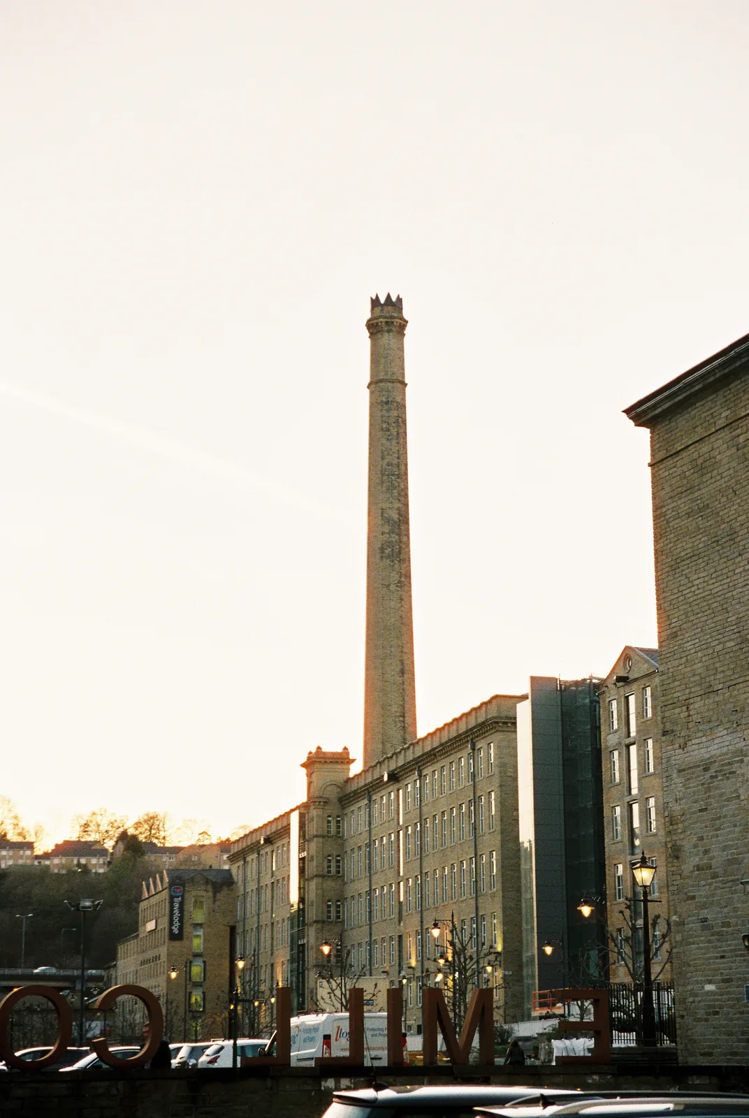 The Dean Clough mills and their chimney at dusk