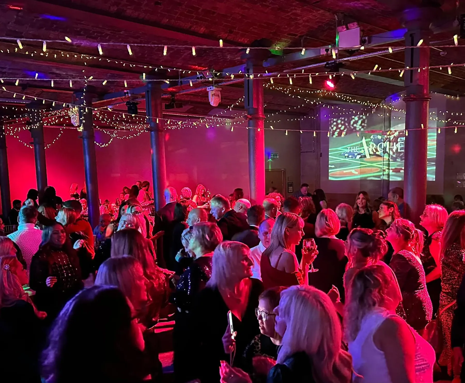 A packed evening dancefloor under the fairy lights